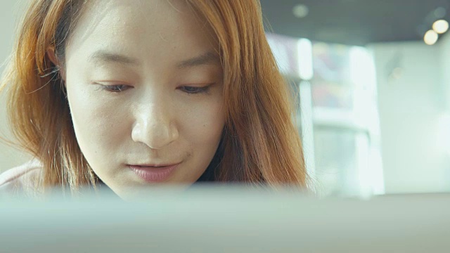 年轻的亚洲女性使用笔记本电脑视频下载
