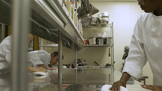餐饮专业学生在餐饮学院清洁工作台面。视频素材