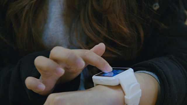 女子站在街上用智能手表视频下载