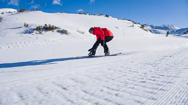 滑雪胜地的滑雪者从山坡上滑下来，在路上表演跳跃技巧视频素材