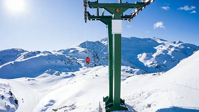 在一个阳光明媚的冬日，在一个山区度假胜地乘坐滑雪缆车视频下载