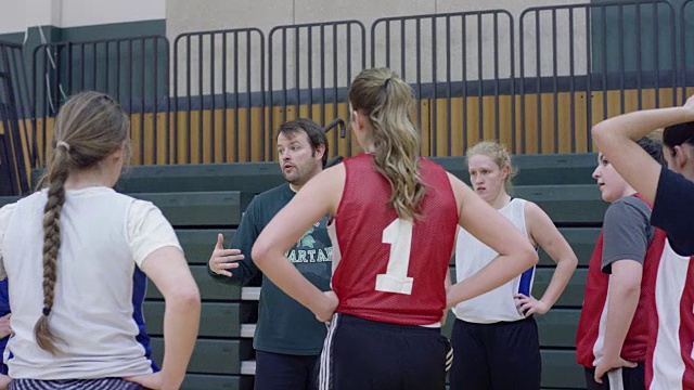 女子篮球队围着教练团团转视频素材