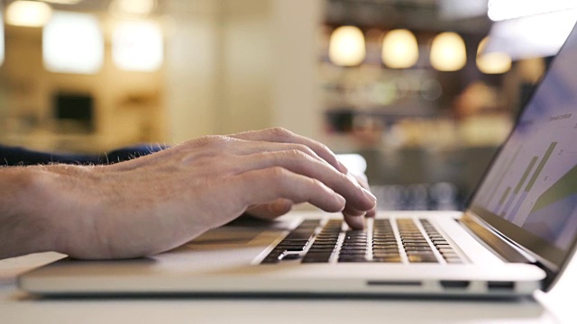 在电脑办公室工作的商人用手指在笔记本电脑键盘上打字视频素材