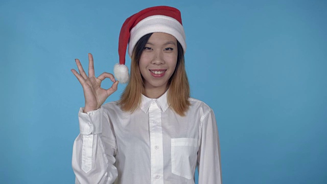 美丽的韩国女性圣诞时间显示出ok的迹象视频素材