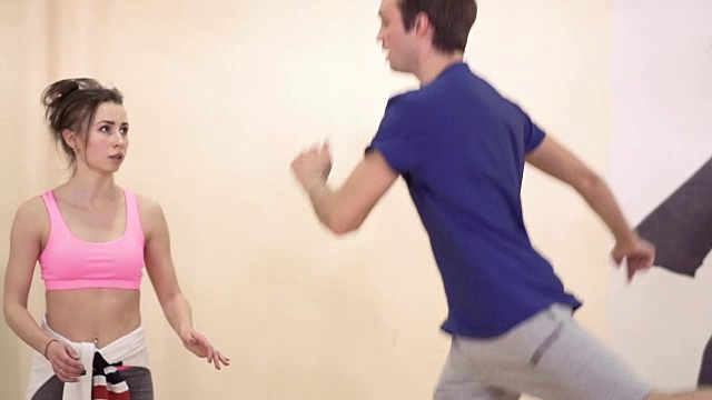 一个年轻人向教练展示了他学过的舞蹈动作视频素材