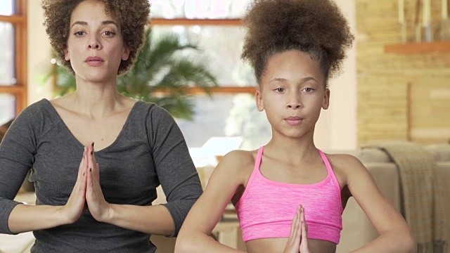 母女俩在客厅做瑜伽视频素材
