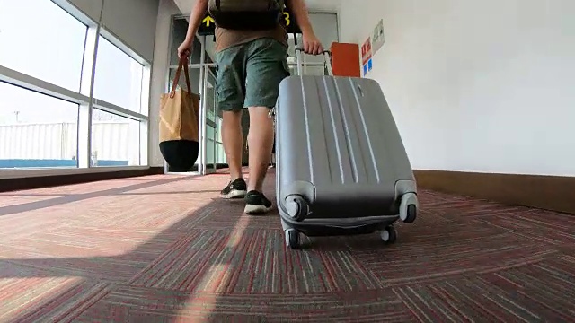 带着行李走过机场航站楼的男子旅客视频素材