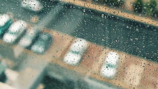 在一个雨天，看着窗外带着雨滴的停车场视频素材