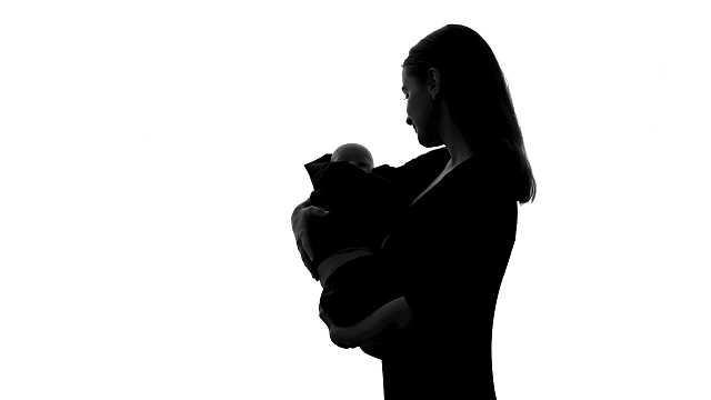 女人抱着娃娃当自己的孩子，为失去新生儿而悲伤，堕胎视频下载