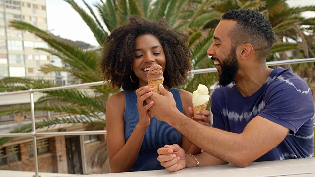 一对情侣在4k海滩吃冰淇淋视频素材