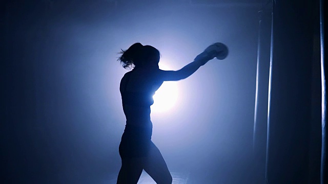 女拳击手在拳击俱乐部锻炼。轮廓视频下载