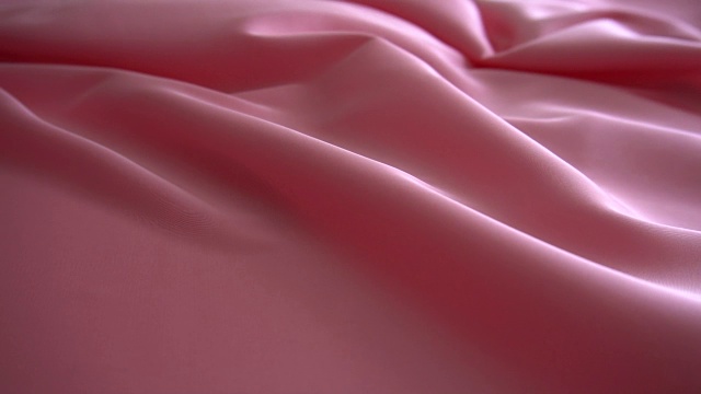 背景纹理柔软的粉红色织物织物材料反向移动。视频素材