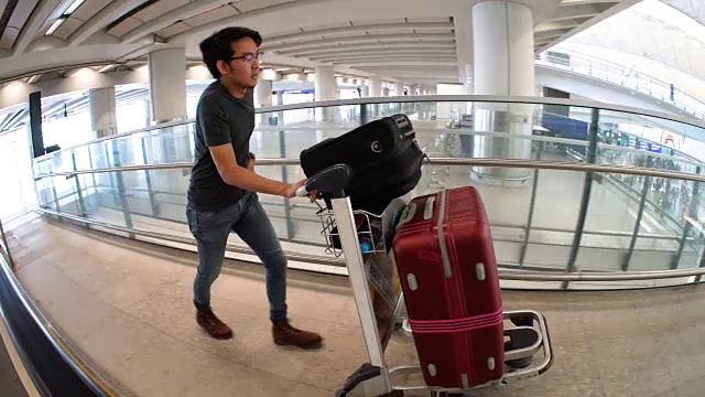 一名男子正在推行李车，办理机场登机手续视频素材