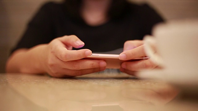 在咖啡馆使用和触摸智能手机的女人视频素材