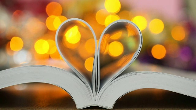 书页装饰成心形，用散景灯庆祝爱情和浪漫情人节的概念视频素材