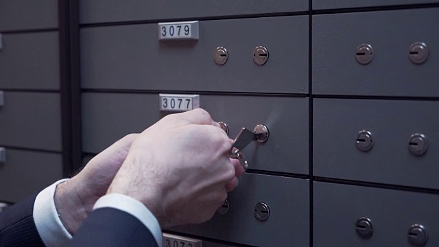 银行经理与客户老汉用两把钥匙锁上了保险箱视频素材