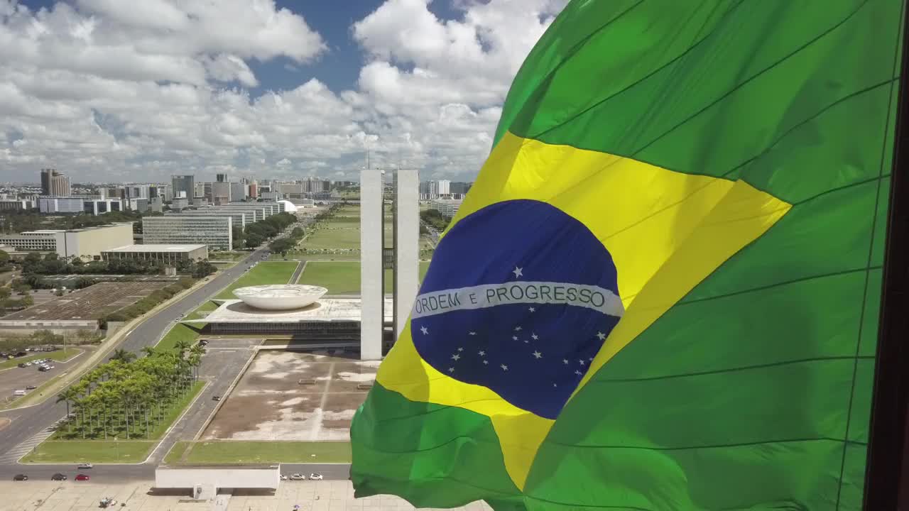 巴西国旗，背景是巴西利亚的城市景观和议会视频素材