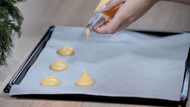 在烤纸上挤出泡芙面团视频素材