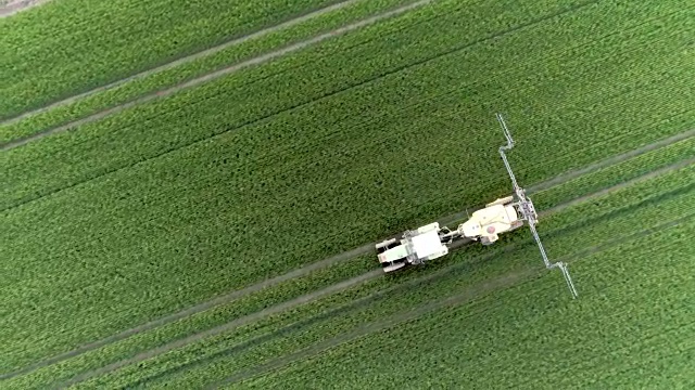 MS航拍拖拉机喷洒绿色作物，斯洛文尼亚视频下载