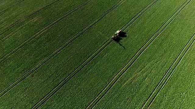 拖拉机在农田里喷洒化肥。视频素材