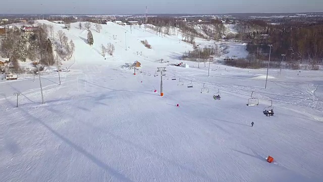 人们在滑雪山上移动缆车在冬季度假村鸟瞰图。滑雪电梯，用于在滑雪胜地的雪山上运输滑雪者和滑雪板视频下载