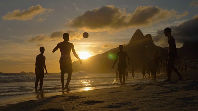 日落时分在巴西伊帕内玛海滩踢沙滩足球视频素材