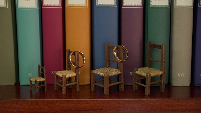 在书的背景上的游戏椅上挂着结婚戒指视频下载