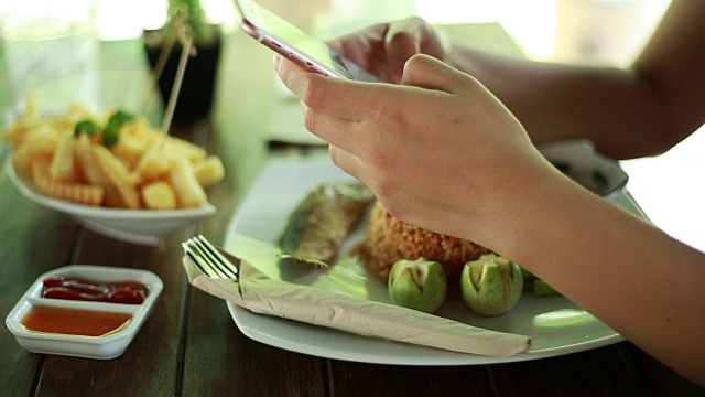 在餐厅使用和触摸智能手机的女性视频素材