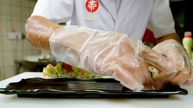 男厨师在厨房用托盘摆放寿司视频素材