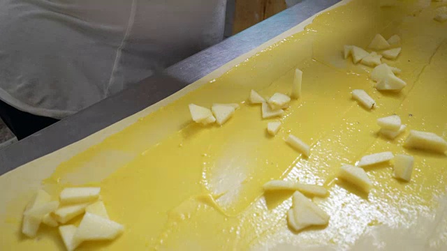传统的意大利面包店。两位女面包师准备用奶油、葡萄干和苹果制作的甜面包视频素材