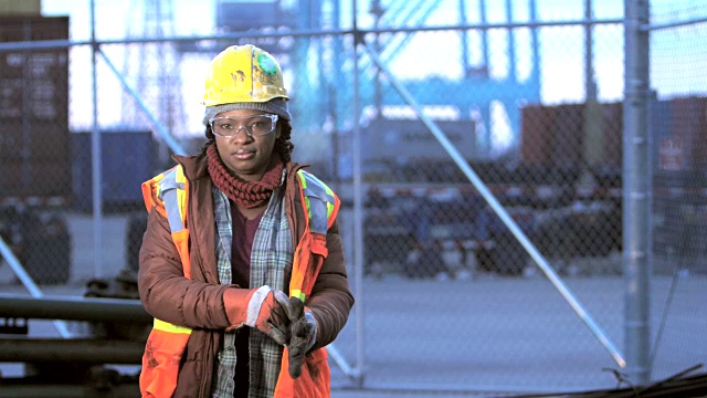 非裔美国妇女在港口，戴着工作手套视频素材