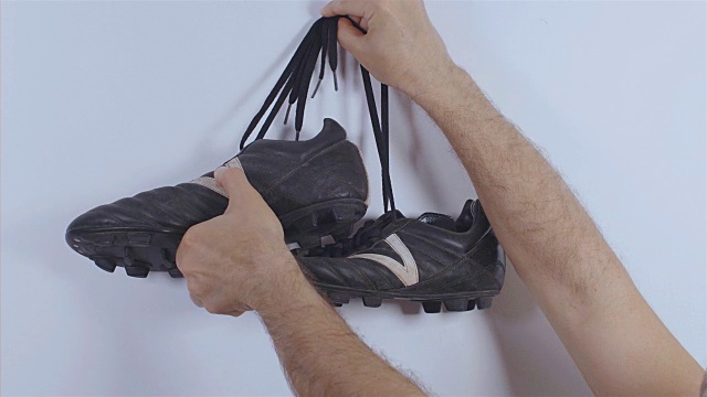 足球运动员把足球靴挂在墙上，4k视频素材