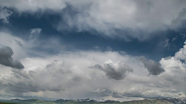 乌云笼罩着山脊，映衬着蓝天。间隔拍摄FullHD视频素材