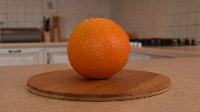 近距离观察整个橙子。以白色厨房为背景的旋转相机。Dolly-shot。视频下载