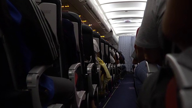 飞机内部，在飞行过程中有乘客在座位上。椅子在过道视频素材