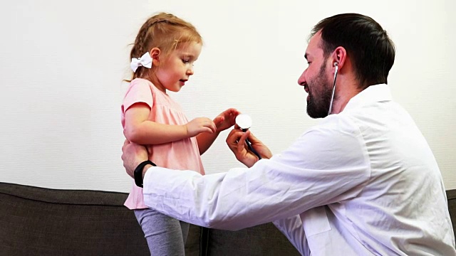 一位父亲和他可爱的女儿在扮演医生。视频下载