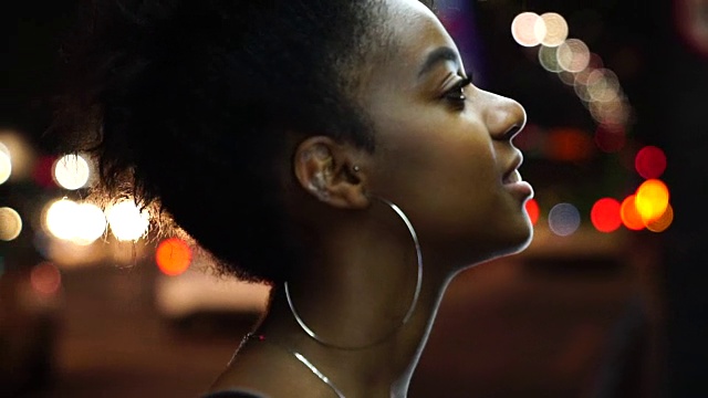 非洲裔年轻女子在夜晚的城市画像视频素材