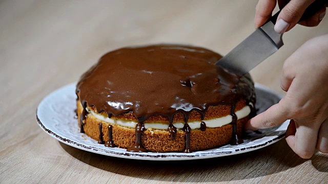 奶油蛋糕和巧克力酱。切一块馅饼视频素材