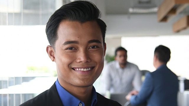 年轻的马来西亚商人对着镜头微笑视频素材