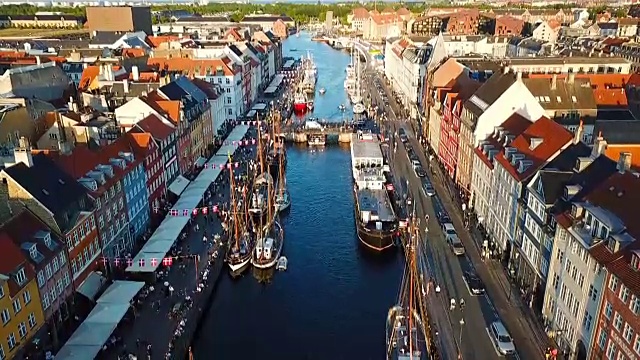 繁忙的哥本哈根，丹麦日落大街。步行，骑自行车，开车。尼哈芬新港口运河和娱乐区。从顶部鸟瞰的视频片段。相机在一个圆圈中旋转。视频素材
