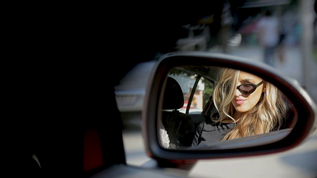 从车的后视镜中映出的漂亮女人视频素材