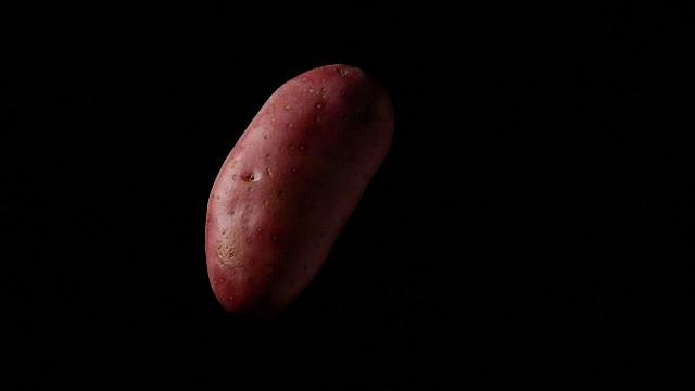 红土豆在黑色背景上旋转视频素材