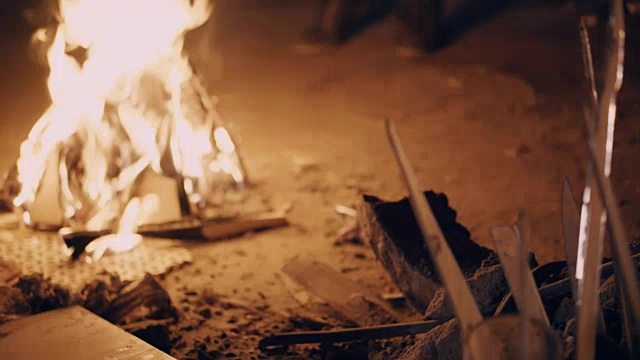 年轻人感到寒冷，就在篝火旁取暖视频素材