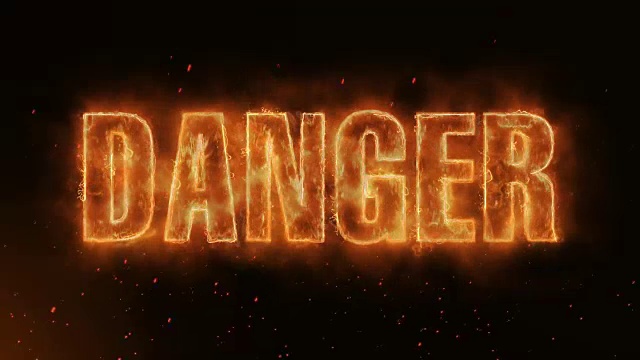 危险单词热燃烧在现实的火火焰火花和烟雾连续无缝循环动画视频素材