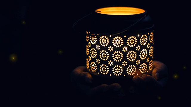 电影-女人的手拿着灯笼与神奇的灯光萤火虫在晚上。视频素材