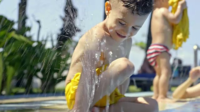 兴奋的小男孩在游泳池里玩视频素材