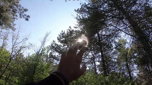 特写举起手在天空中对着太阳的自然，和平，希望，相机的运动视频下载
