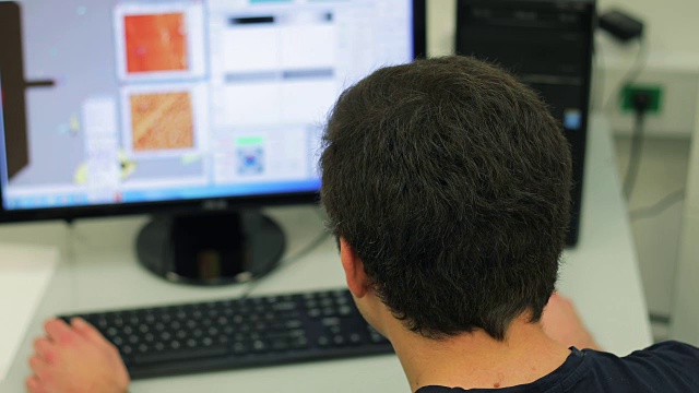 在实验室使用计算机的年轻研究员视频下载