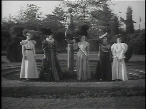 1939年，在世界博览会/纽约，美国纽约，蒙太奇妇女展示新旧时装走过花园视频素材