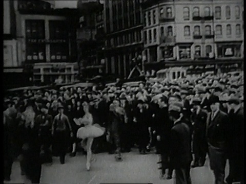 1930蒙太奇芭蕾舞者在街道中央与一群跟随她的人跳舞/美国纽约视频下载